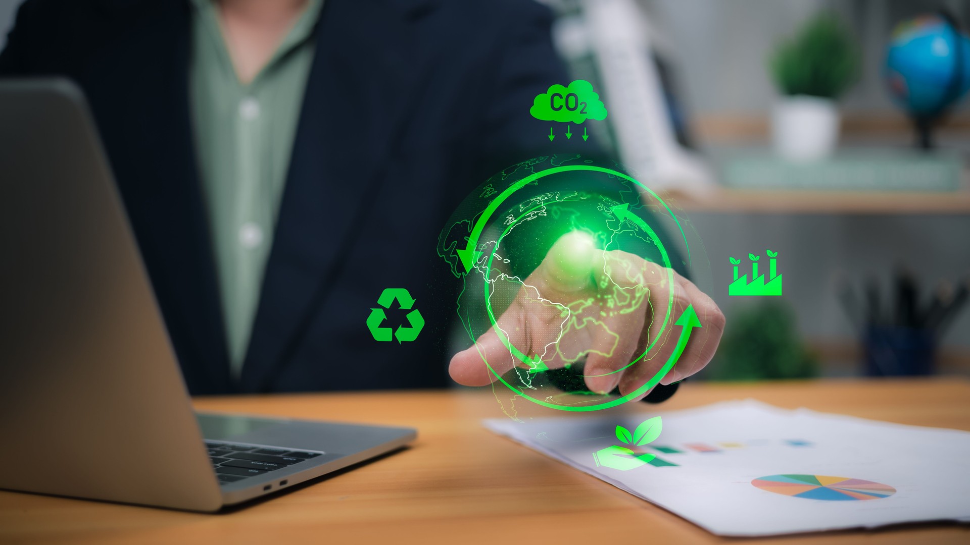 Person with glowing green holographic earth and eco icons for sustainability and green business